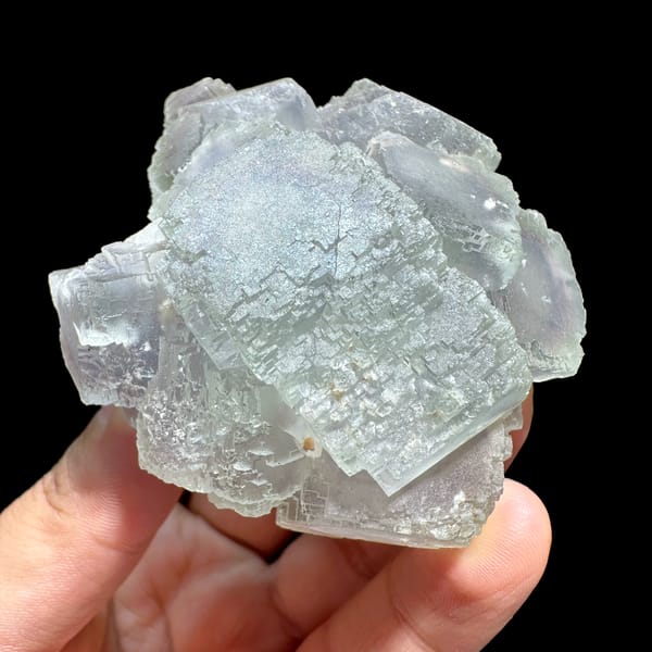 Window-faced stepped fluorite cluster with purple zoning from Guangxi, China, close-up of the crystal faces