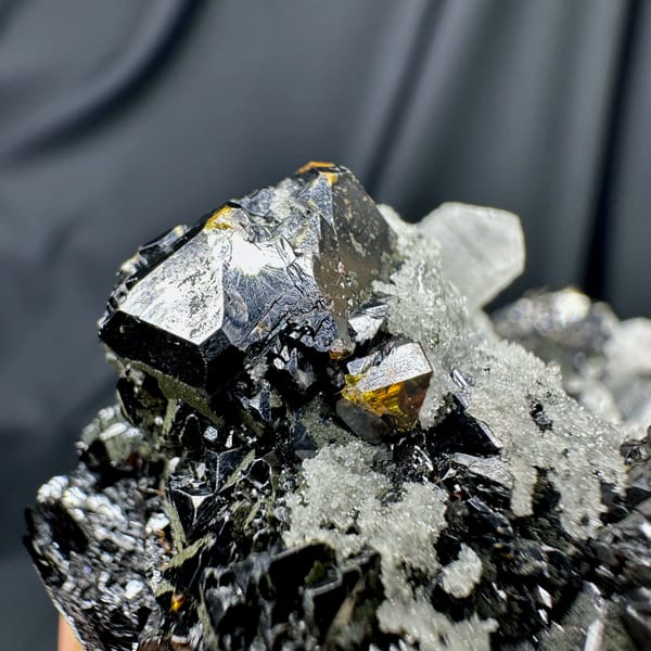 Black botryoidal marmatite with clear quartz needles from Inner Mongolia, China, close-up of the crystal faces