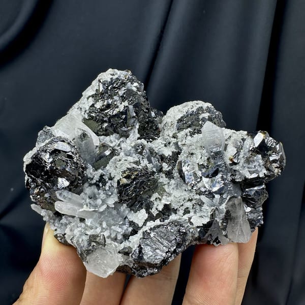 Black botryoidal marmatite with clear quartz needles from Inner Mongolia, China, detail of the matrix contact