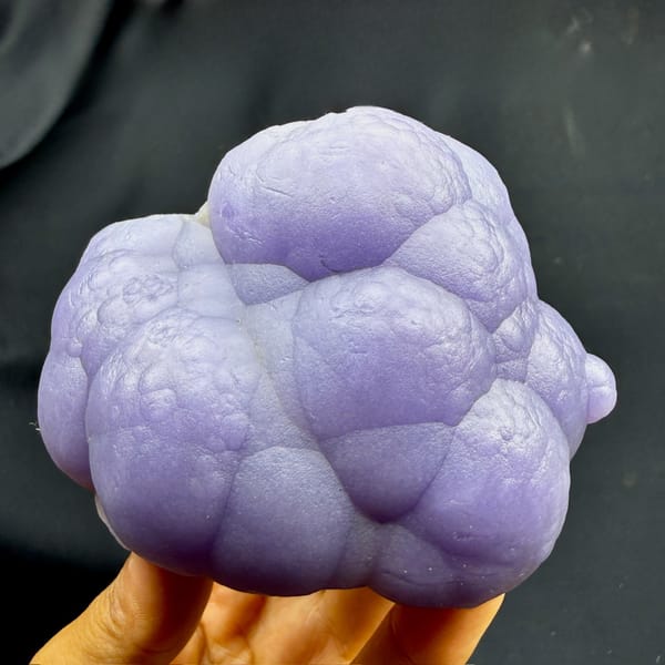Lavender botryoidal agate mass with purple fluorite from Henan, China, detail of the matrix contact