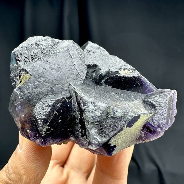 Deep purple phantom fluorite glowing when, from Inner Mongolia, China, close-up of the crystal faces
