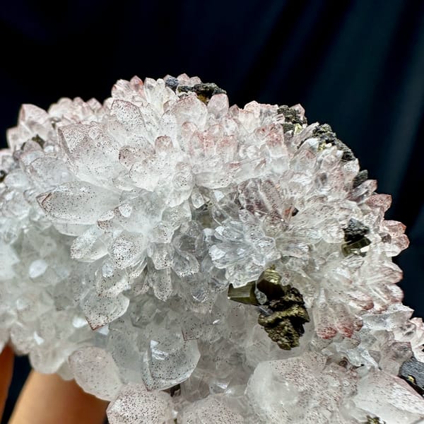 Pale red hematoid quartz crystals with chalcopyrite from Jiangxi, China, close-up of the crystal faces