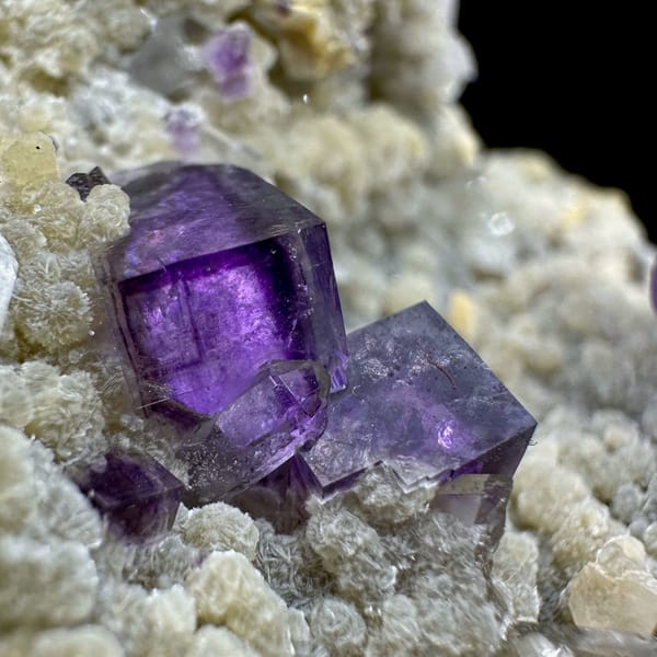 Deep purple fluorite cubes on tan quartz and mica from Yaogangxian Mine, Hunan, China, reverse side