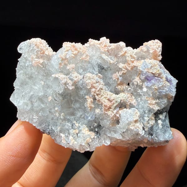 Pale blue fluorite cubes with pink rhodochrosite crusts from Guangxi, China, second angle