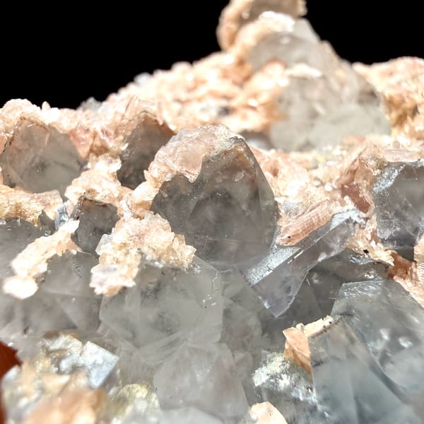 Pale blue fluorite cubes with pink rhodochrosite crusts from Guangxi, China, reverse side