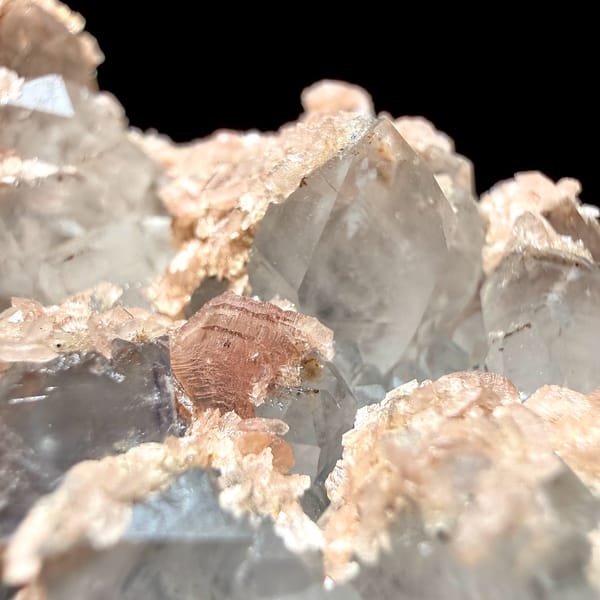 Pale blue fluorite cubes with pink rhodochrosite crusts from Guangxi, China, top view