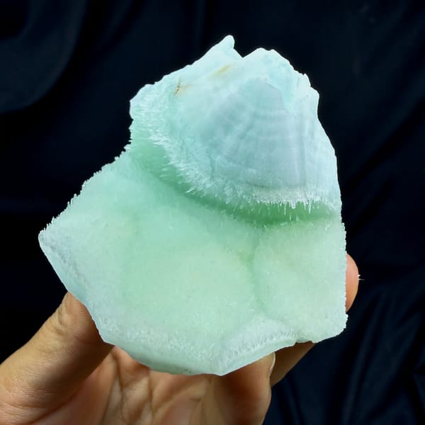Smooth aqua-green acicular aragonite plate from Yunnan, China, close-up of the crystal faces