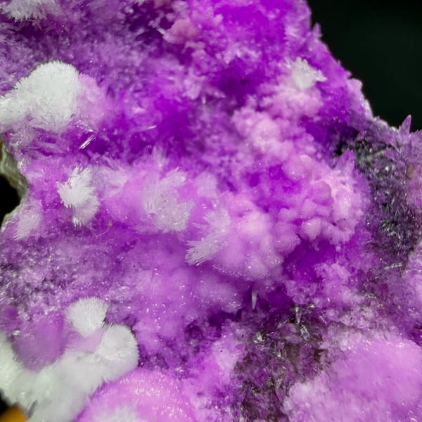 Slender wedge of vivid magenta aragonite from Yunnan, China, close-up of the crystal faces
