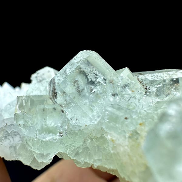 Plate of pale green fluorite cubes with inclusions on white quartz from Guangdong, China, top view