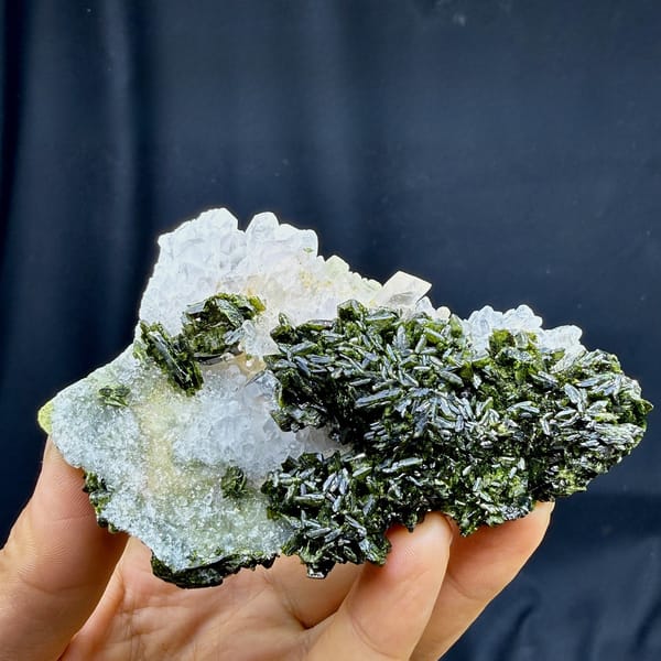 Dark green epidote thicket beside clear quartz points from Sichuan, China, detail of the matrix contact