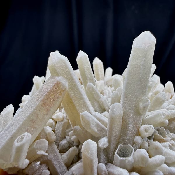 Sugar-textured pale quartz needles in spiky cluster from Guangdong, China, close-up of the crystal faces