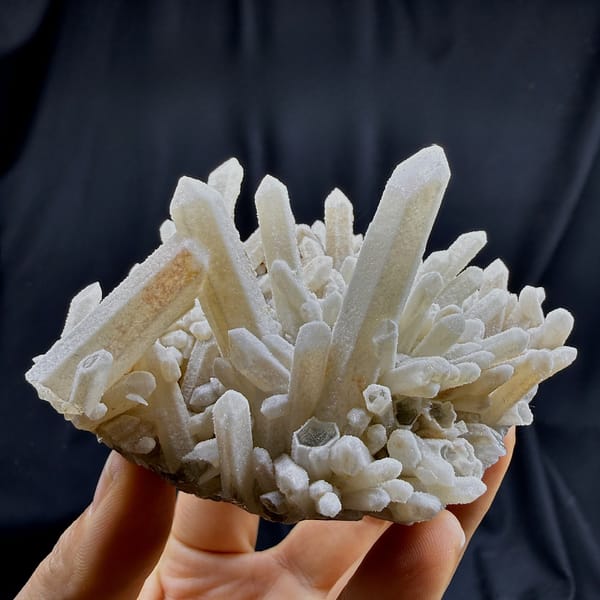 Sugar-textured pale quartz needles in spiky cluster from Guangdong, China, detail of the matrix contact