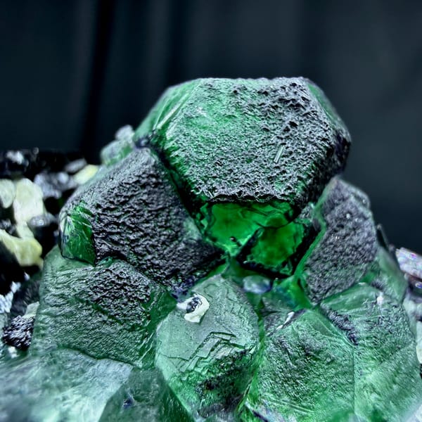 Emerald-green garden fluorite cubes with black tourmaline from Namibia, reverse side