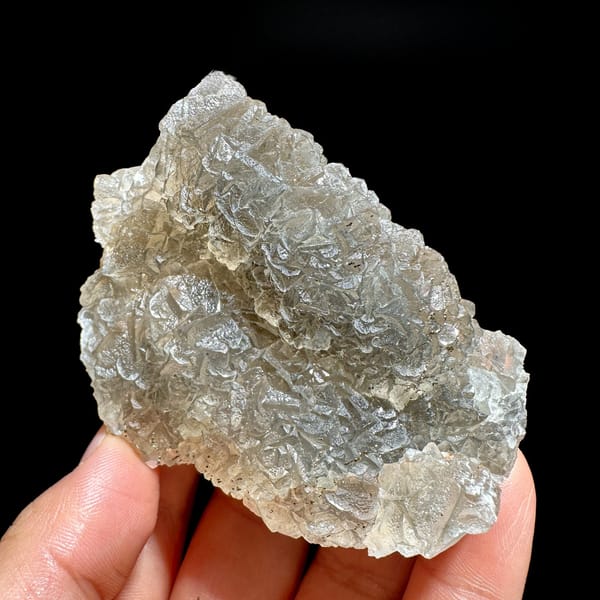 Grey-green fluorite mass sprinkled with pyrite from Xianghualing, Hunan, China, detail of the matrix contact