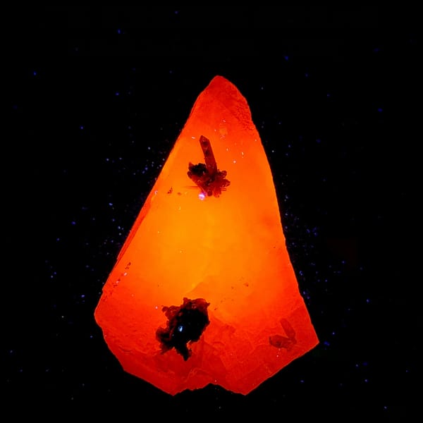 Calcite crystal with green phantom quartz fluorescing red-orange under UV, from Guangdong, China