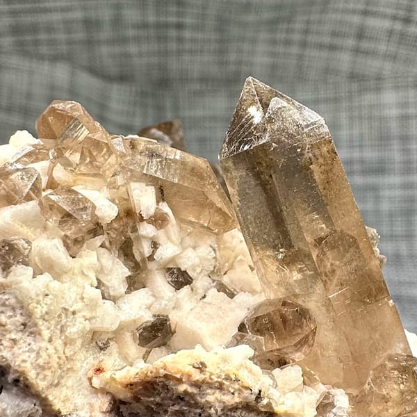 Smoky quartz points on cream feldspar from Yunxiao, Fujian, China, top view