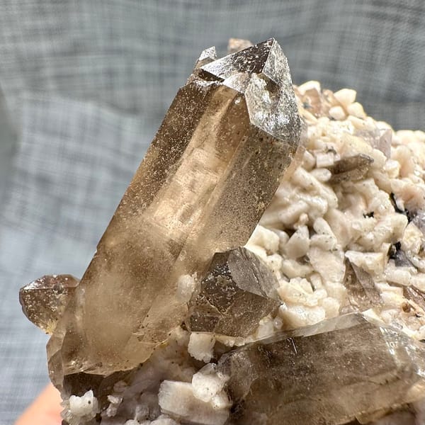 Smoky quartz points on cream feldspar from Yunxiao, Fujian, China, overall view