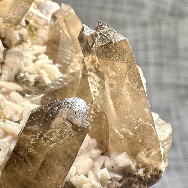 Smoky quartz points on cream feldspar from Yunxiao, Fujian, China, another angle