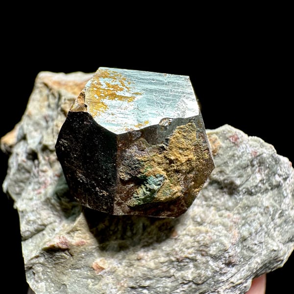 Single pyritohedral pyrite crystal on grey rock slab from Guangxi, China, second angle