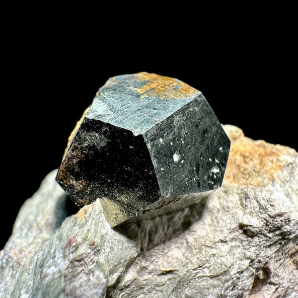 Single pyritohedral pyrite crystal on grey rock slab from Guangxi, China, reverse side