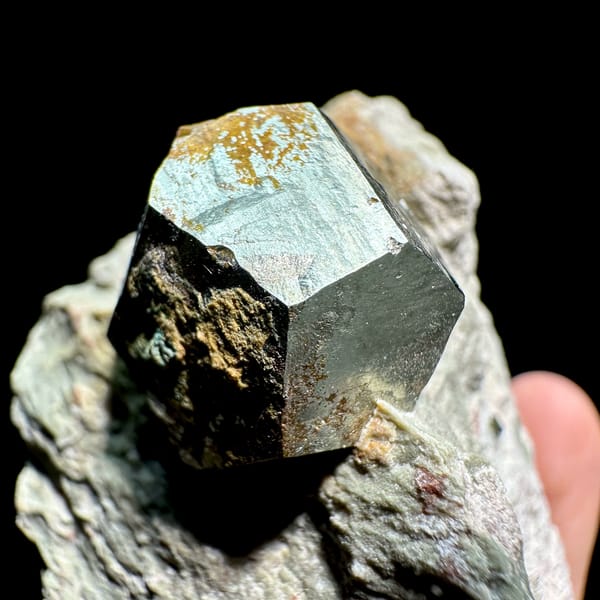 Single pyritohedral pyrite crystal on grey rock slab from Guangxi, China, top view