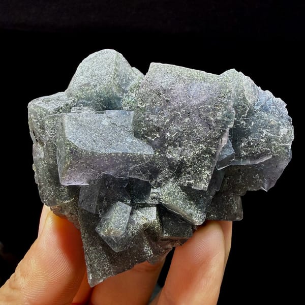 Blue-green daylight fluorite cubes enclosing pyrite from Nigeria, close-up of the crystal faces
