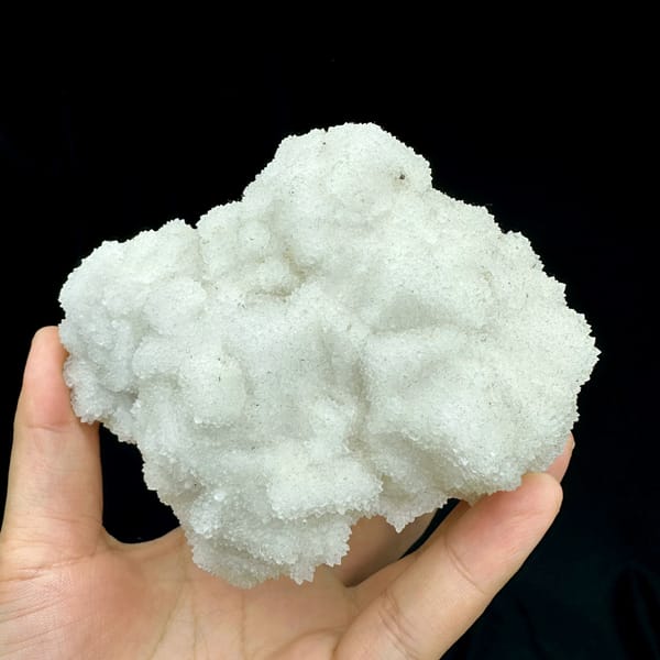 Hollow-shell quartz mass of sparkling white druse from Fujian, China, close-up of the crystal faces