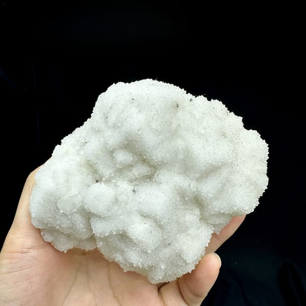 Hollow-shell quartz mass of sparkling white druse from Fujian, China, detail of the matrix contact