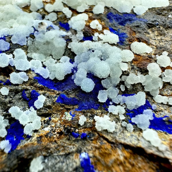 White aragonite balls with royal-blue azurite vein on rusty rock from Yunnan, China, second angle