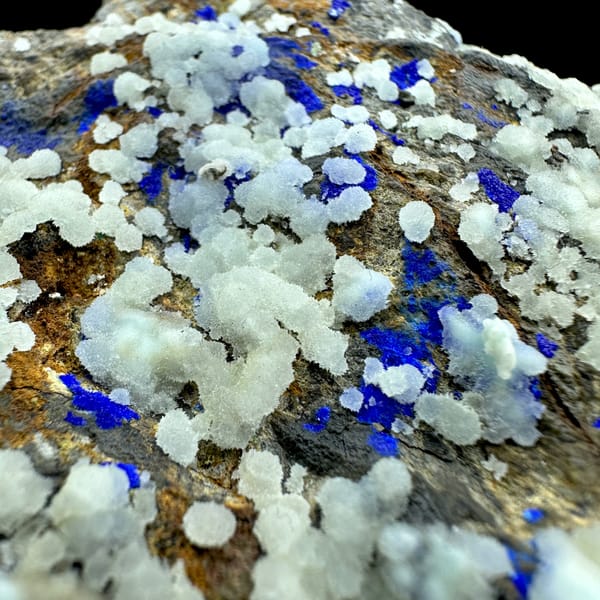 White aragonite balls with royal-blue azurite vein on rusty rock from Yunnan, China, reverse side