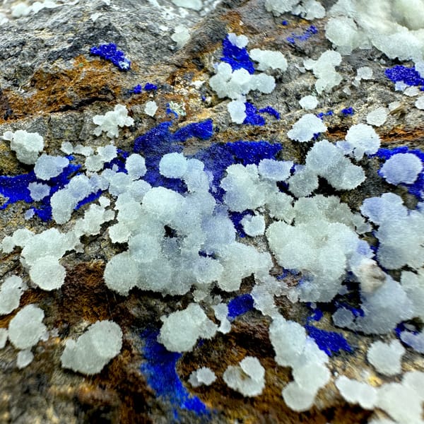 White aragonite balls with royal-blue azurite vein on rusty rock from Yunnan, China, top view