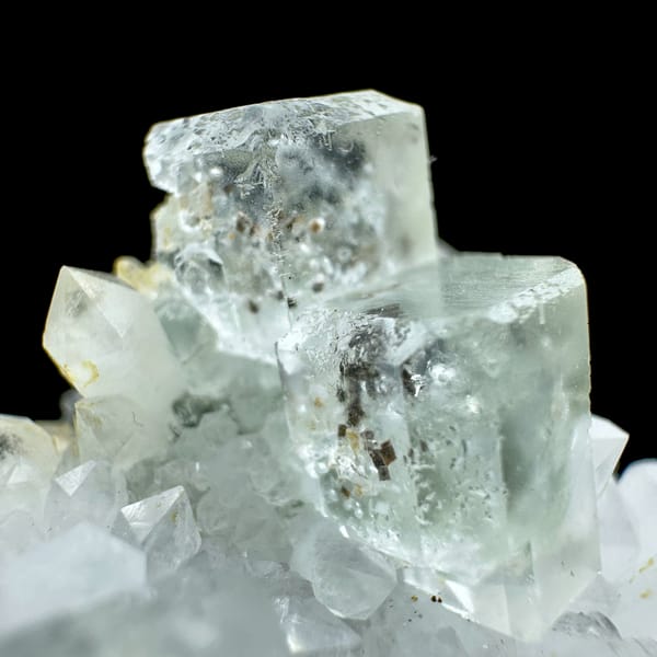 Pale green fluorite cubes with inclusions on white quartz from Guangdong, China, top view