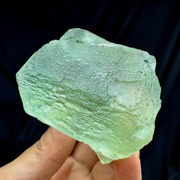 Single large translucent green fluorite cube from Fujian, China, close-up of the crystal faces