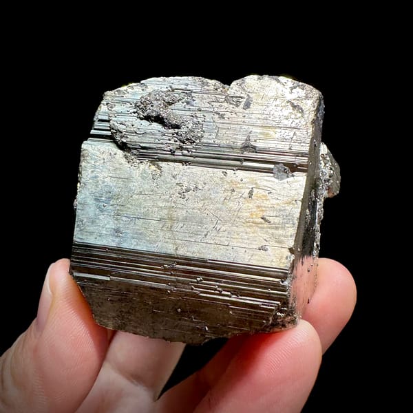 Heavy striated pyrite floater with satin gold lustre from Hunan, China, second angle