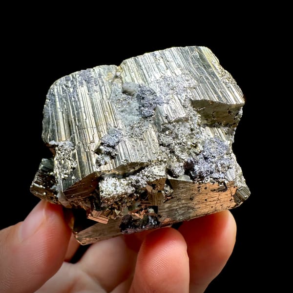 Heavy striated pyrite floater with satin gold lustre from Hunan, China, top view