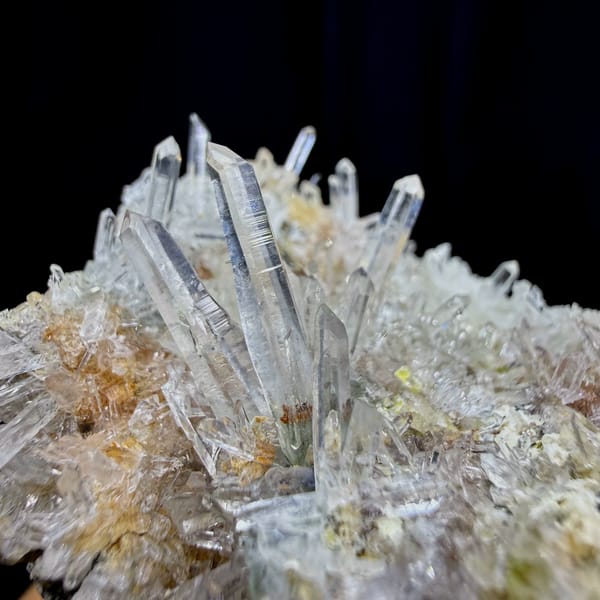 Clear quartz needles bristling over pale base from Guangdong, China, close-up of the crystal faces