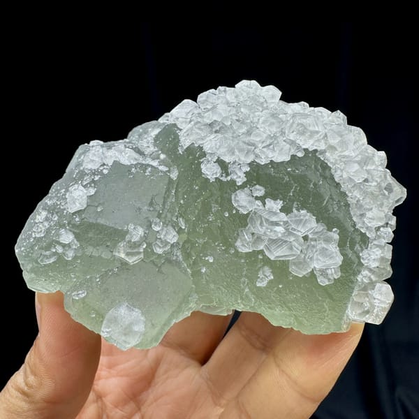 Pale green fluorite balls under white calcite frosting from Fujian, China, second angle