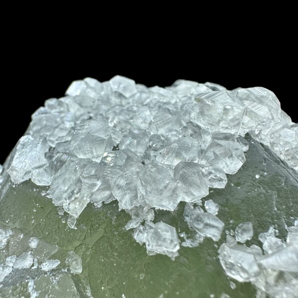 Pale green fluorite balls under white calcite frosting from Fujian, China, top view