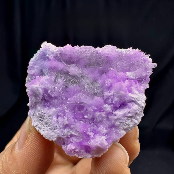 Violet aragonite with clear selenite blades from Yunnan, China, held in hand