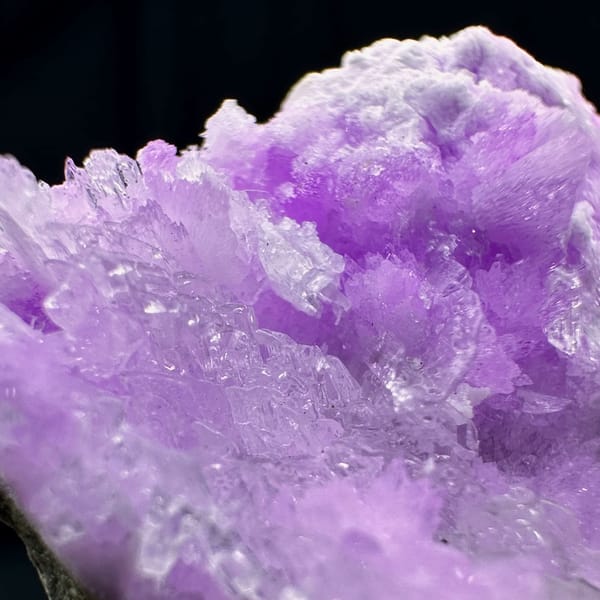 Violet aragonite with clear selenite blades from Yunnan, China, close-up of the crystal faces