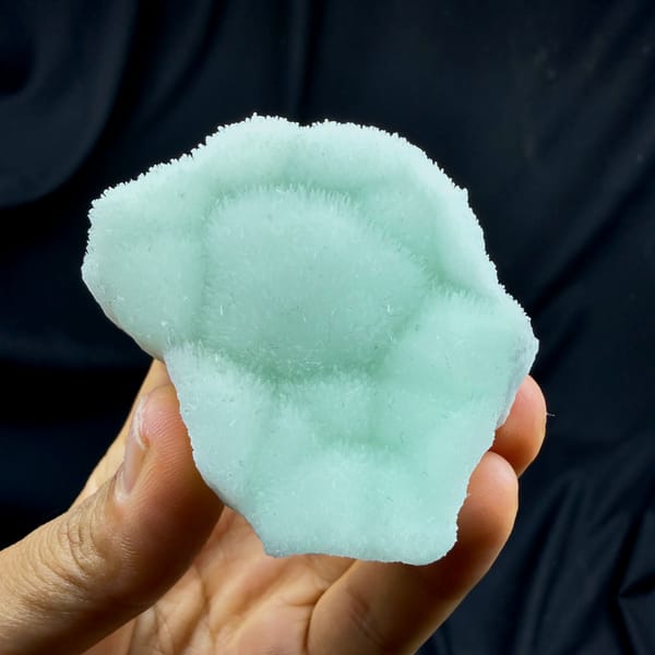 Soft aqua-green aragonite plate with radiating centre from Yunnan, China, top view