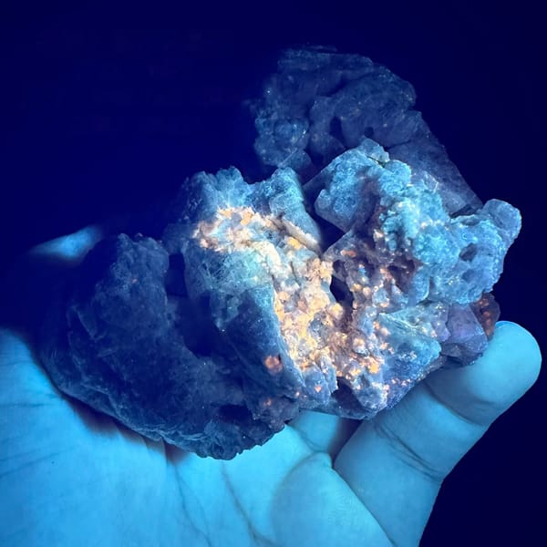 Purple spinel in marble under UV light, from Vietnam