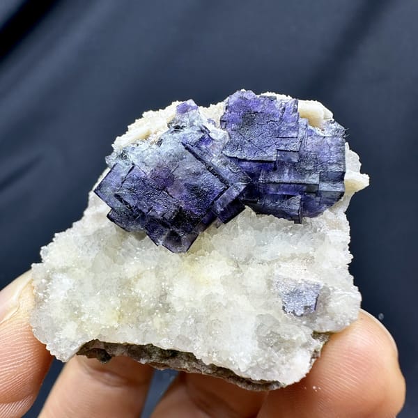 Purple-edged fluorite cubes on white quartz druse from Inner Mongolia, China, detail of the matrix contact