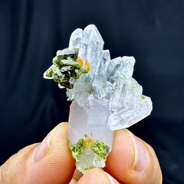 Clear quartz spire with dark green epidote from Sichuan, China, held in hand