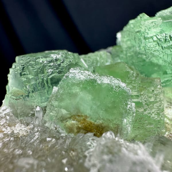Glassy green fluorite cubes on white quartz druse from Fujian, China, second angle