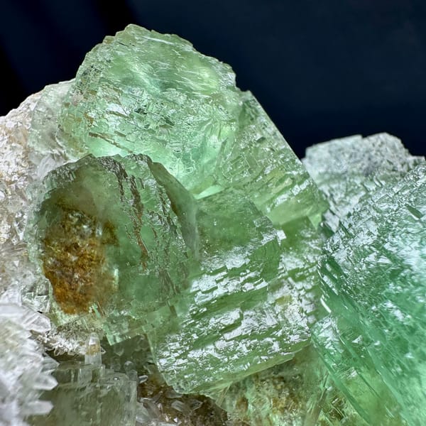 Glassy green fluorite cubes on white quartz druse from Fujian, China, reverse side
