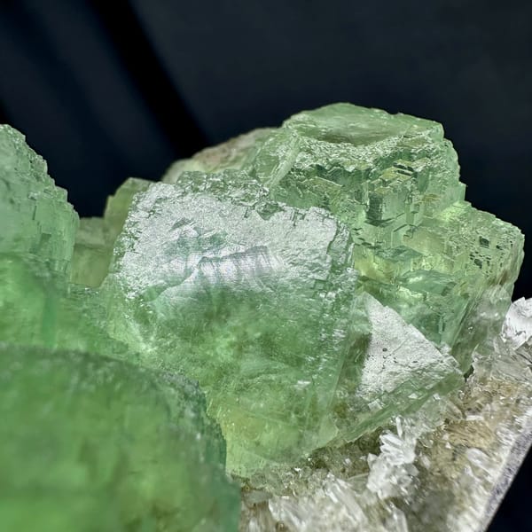 Glassy green fluorite cubes on white quartz druse from Fujian, China, top view
