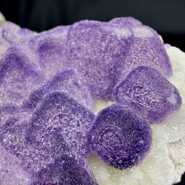 Frosted lavender fluorite cubes beside white quartz druse from Guizhou, China, second angle