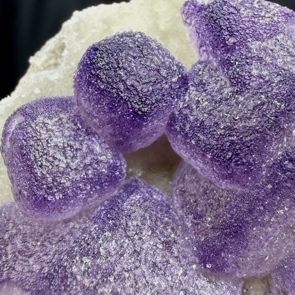 Frosted lavender fluorite cubes beside white quartz druse from Guizhou, China, reverse side