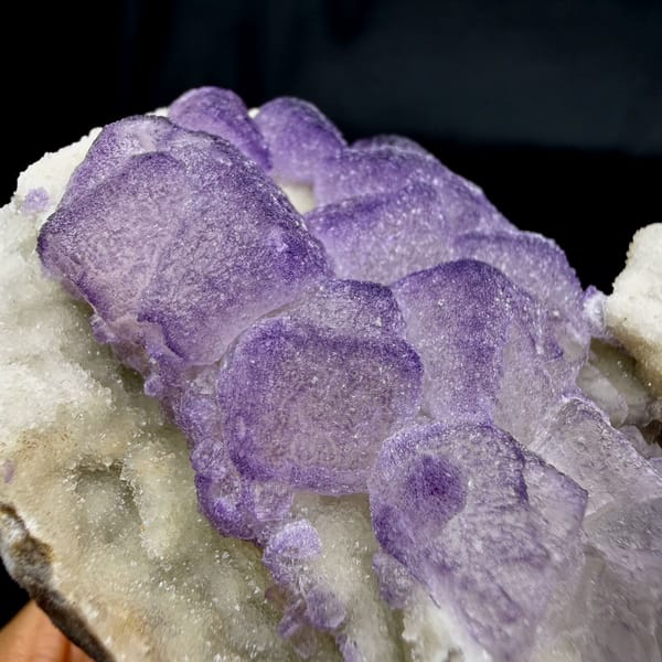 Frosted lavender fluorite cubes beside white quartz druse from Guizhou, China, top view